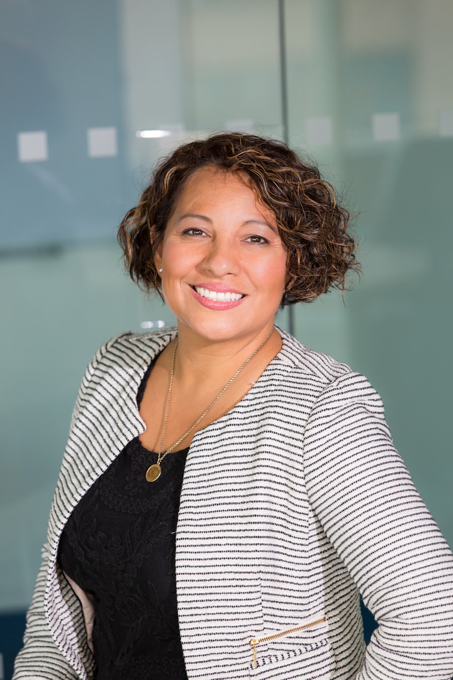 A guidance counsellor smiling in a bright room.