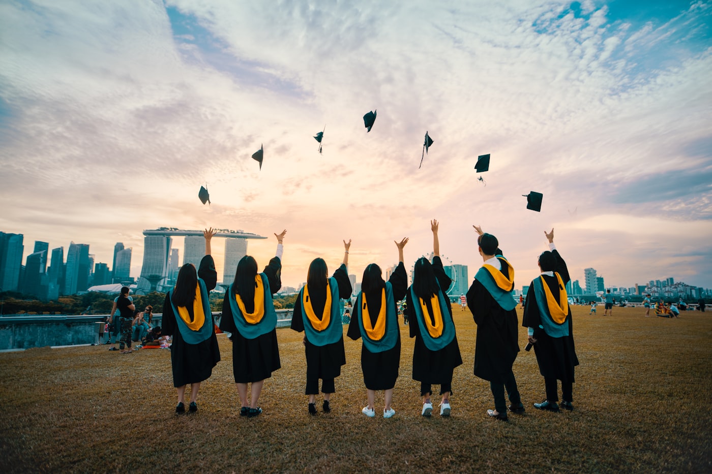 Graduates throwing their caps in the air at the end of a ceremony.