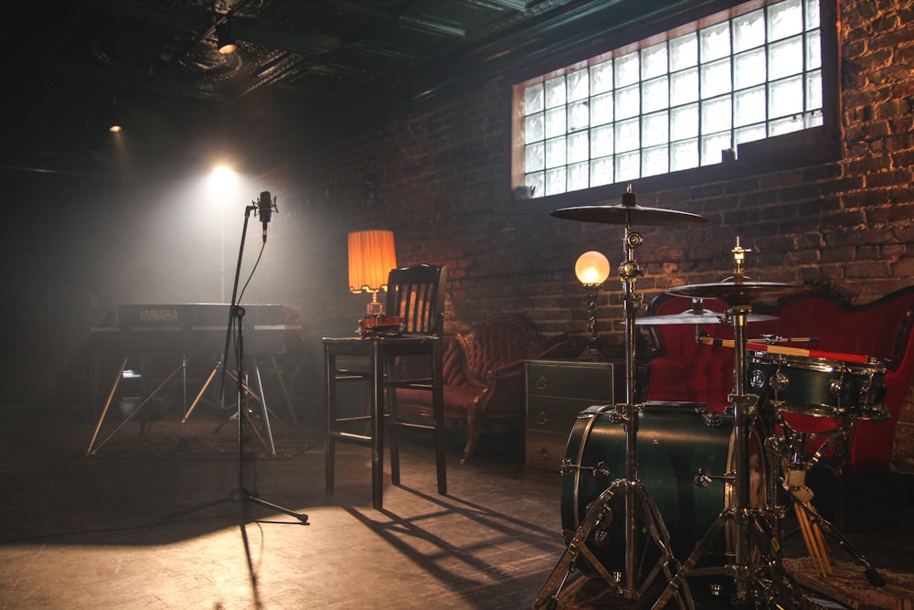 A drum kit and instruments set up in a rehearsal room.