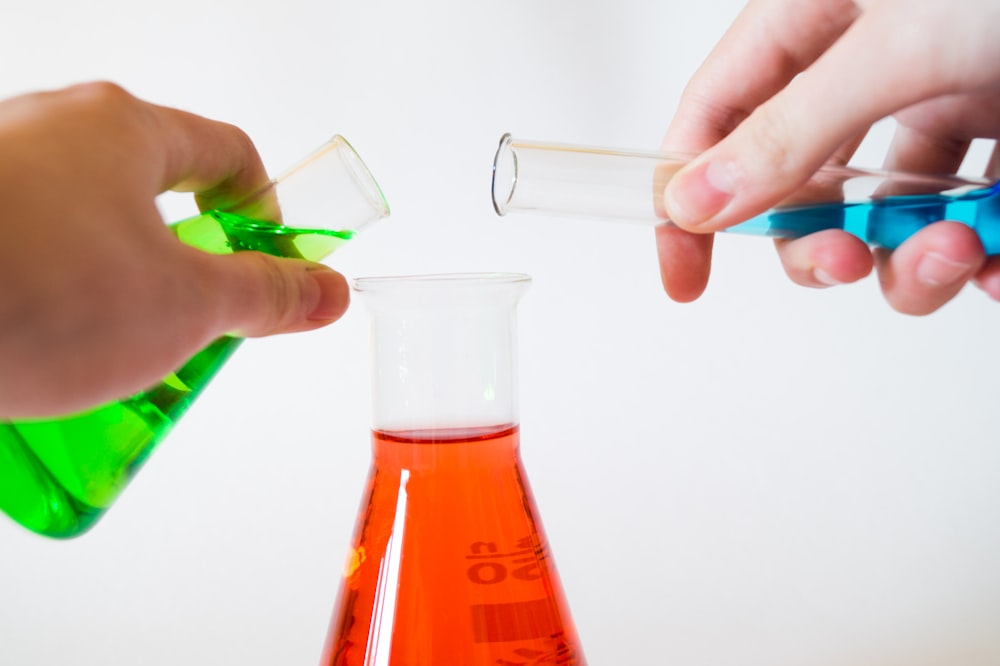 Chemistry flasks holding brightly coloured liquid.